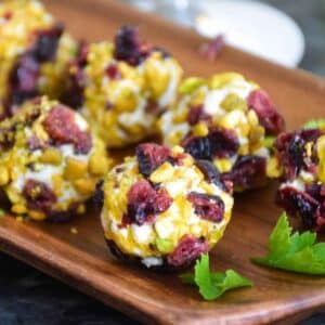 Up close image of goat cheese balls rolled in pistachio and cranberries.