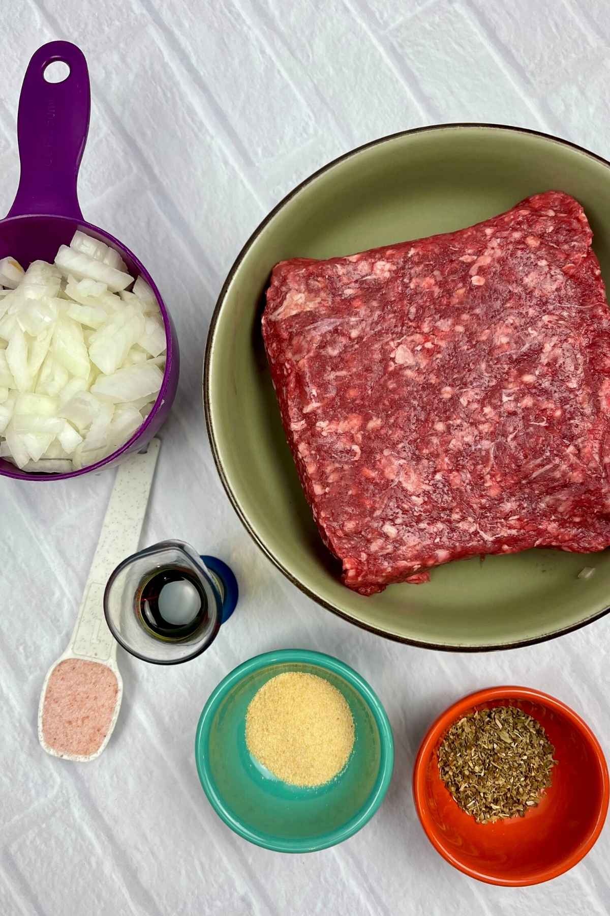 Pizza ingredients: ground beef, onion, oil, salt, garlic powder, italian seasoning.