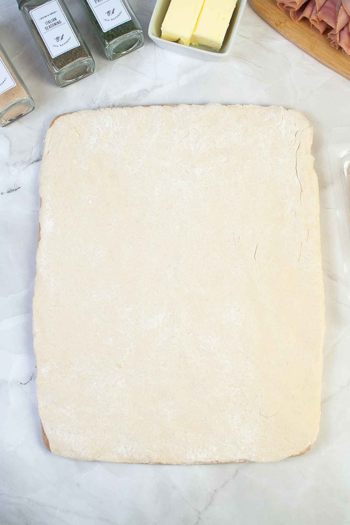 Dough rectangle on hard surface.