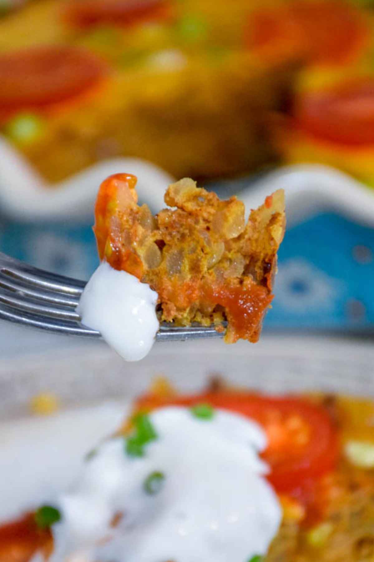 Bite shot of mexican hashbrown casserole.