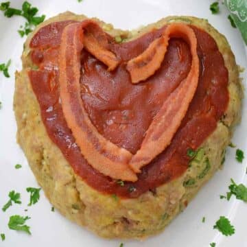 Heart shaped meatloaf made with ground veal and low carb ingredients with bacon topping.