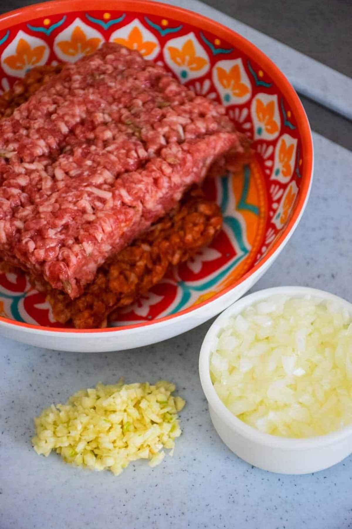 Ground sausage, diced onions, and minced garlic.