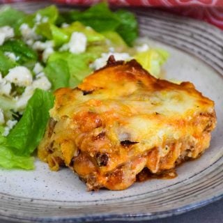 Low Carb Lasagna slice on plate with side salad