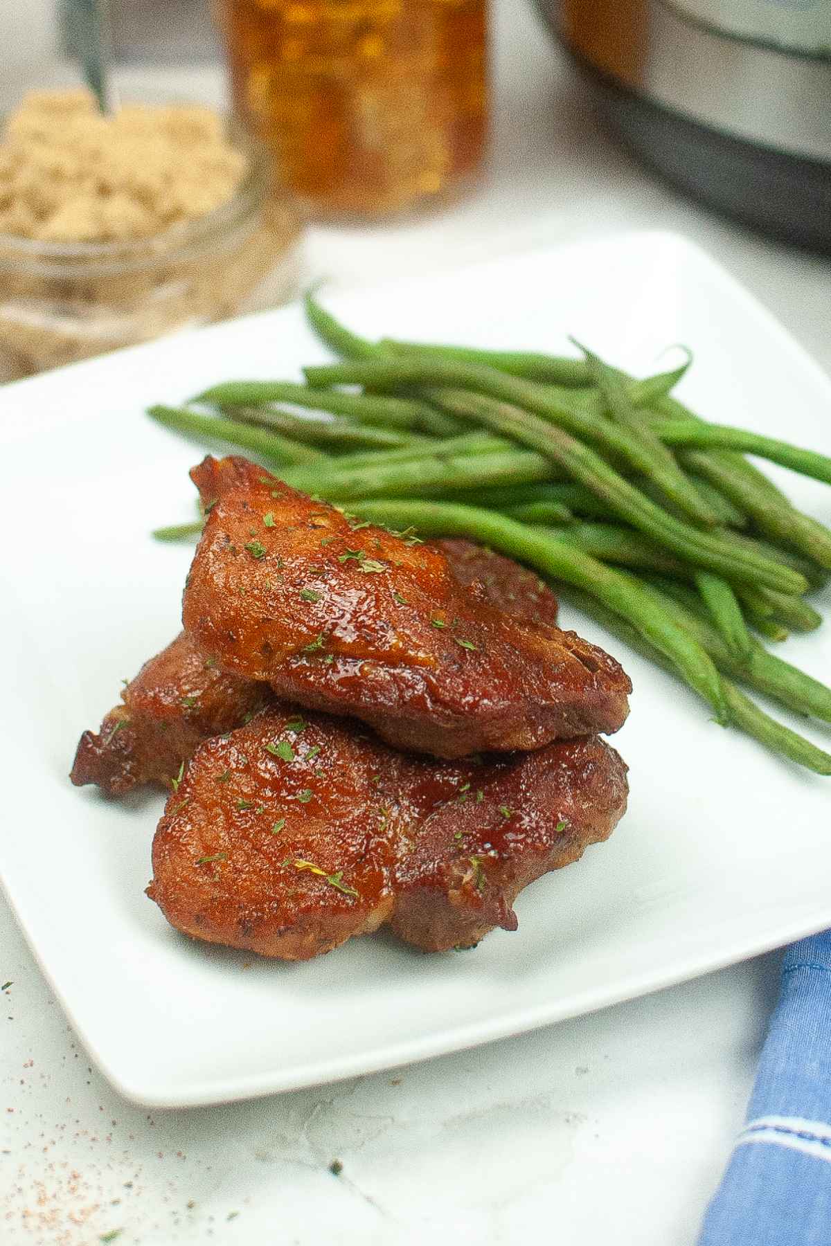 Instant Pot Country Style Ribs on a white plate with a side of green beans.