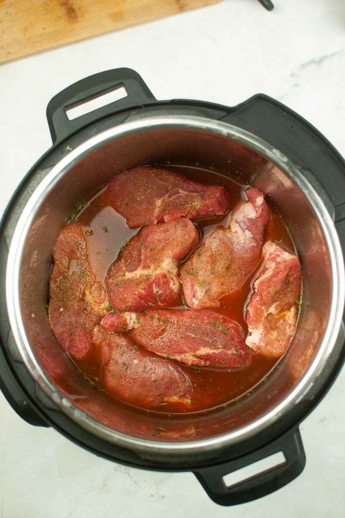 Raw meat in broth in an instant pot.