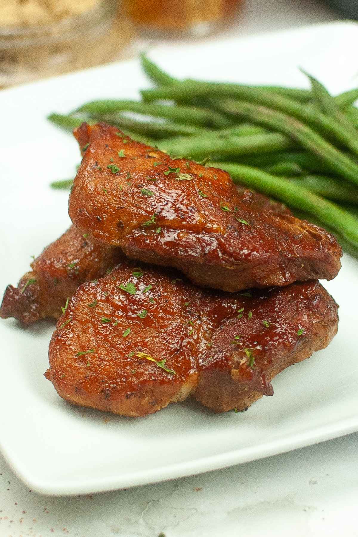 Up close image of ribs on a plate with a side of green beans.