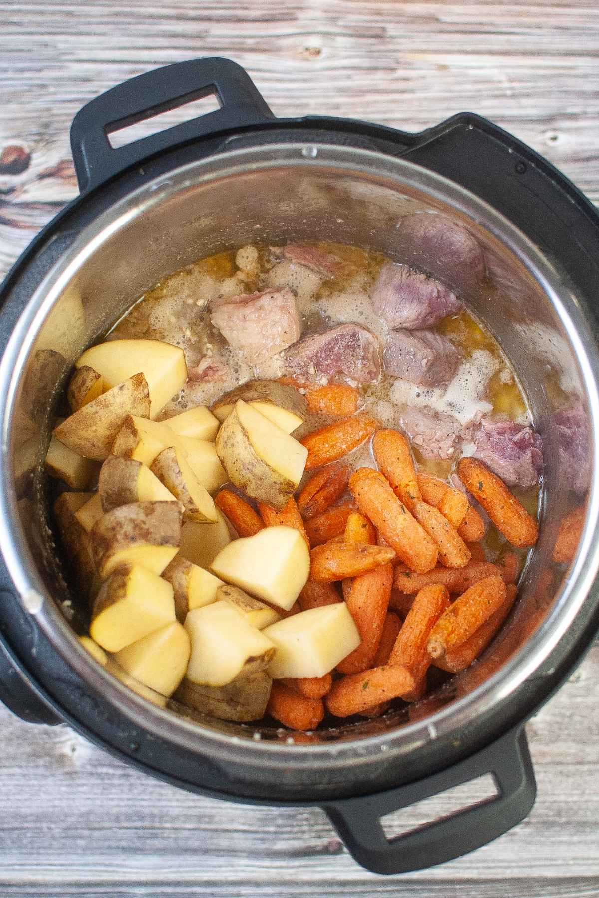 All of the roast ingredients in the instant pot.