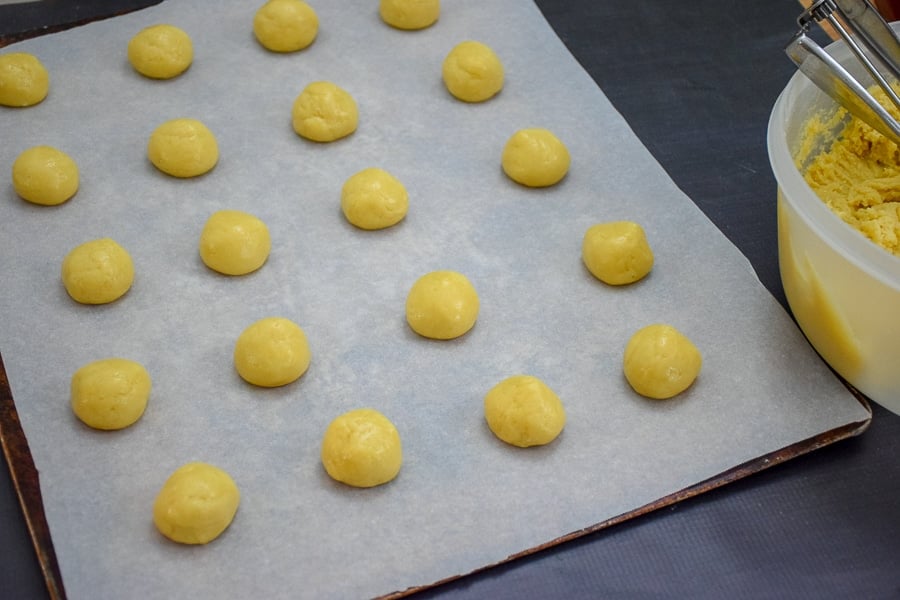 Dough is shaped into 1" balls and placed 1" apart on parchment lined cookie sheet.