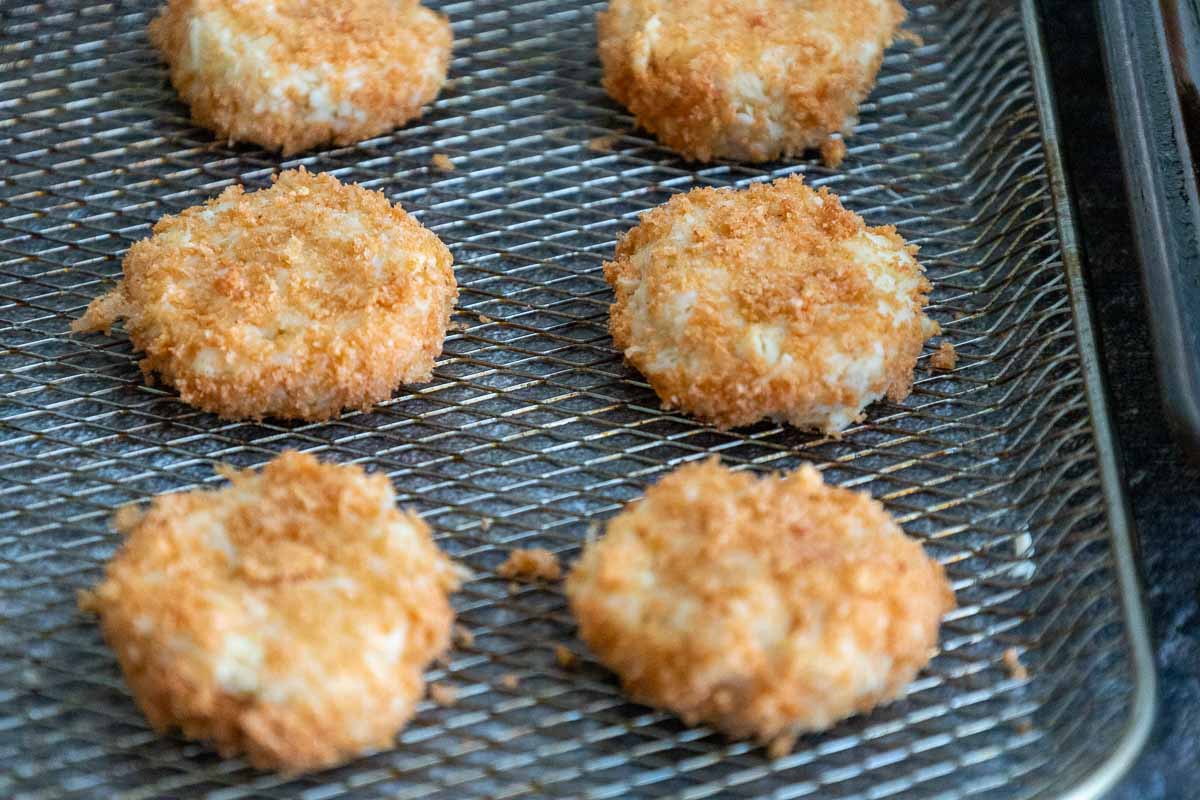 Keto Chicken Nuggets coated with pork rinds on an air fryer tray.
