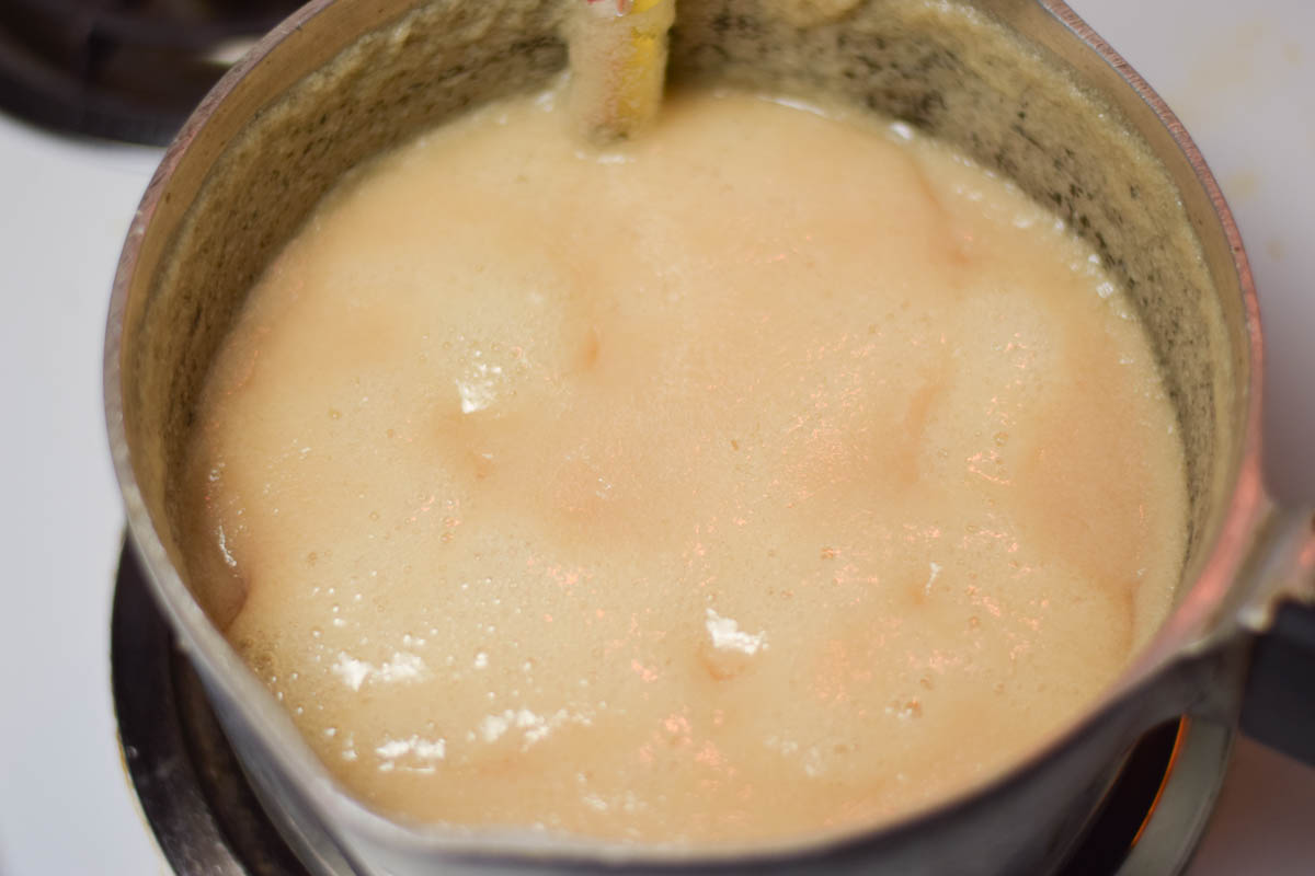 Boiling fudge ingredients in a saucepan.