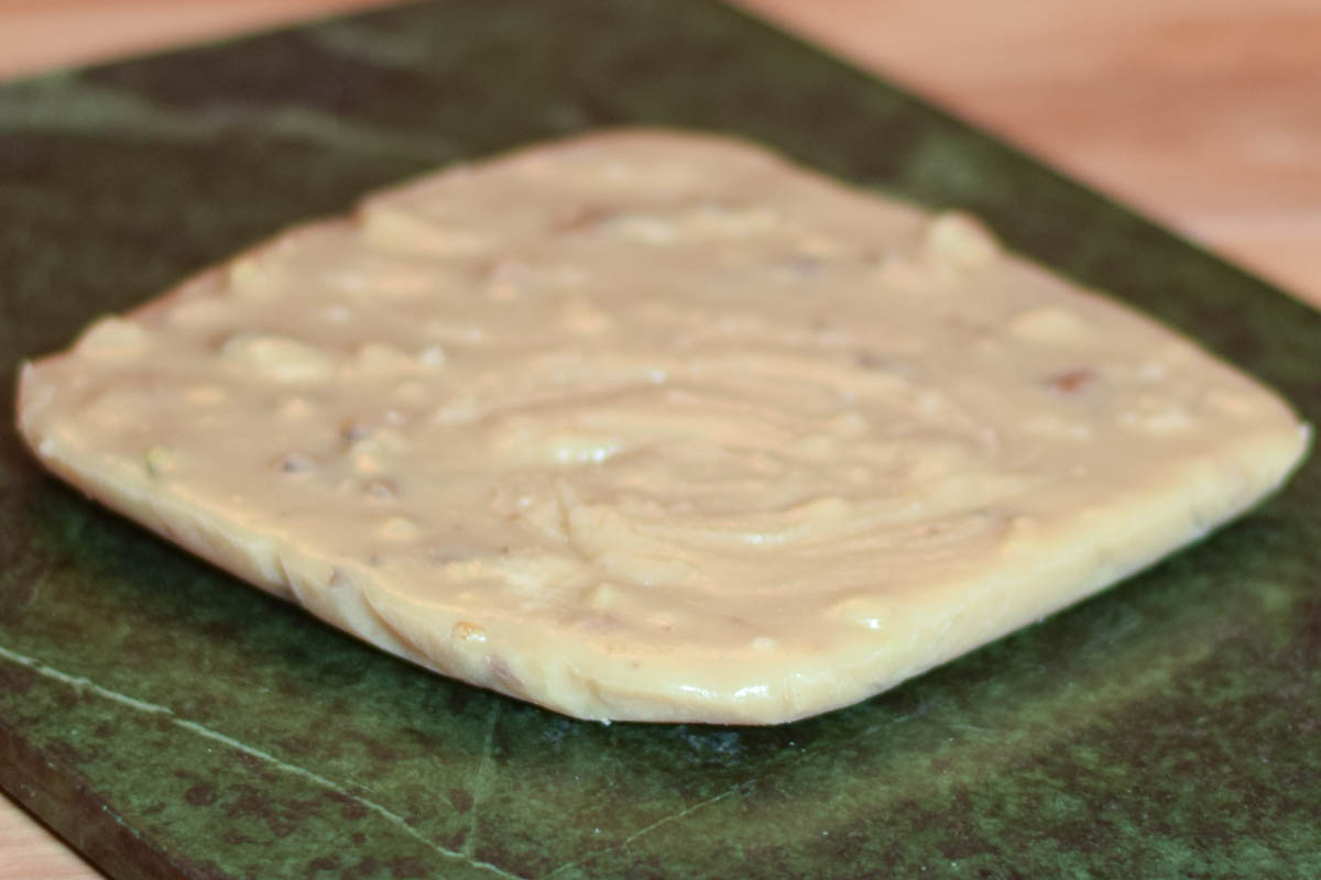 Uncut Maple walnut fudge on a marble board.