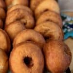 A tray full of homemade buttermilk doughnuts on paper towel lined baking sheet.