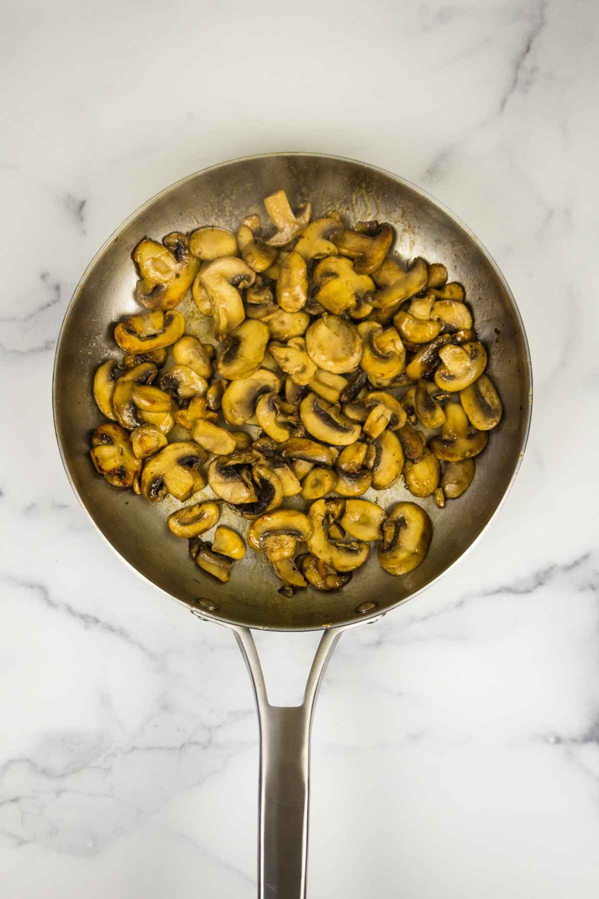 Sauteed mushrooms in a skillet.