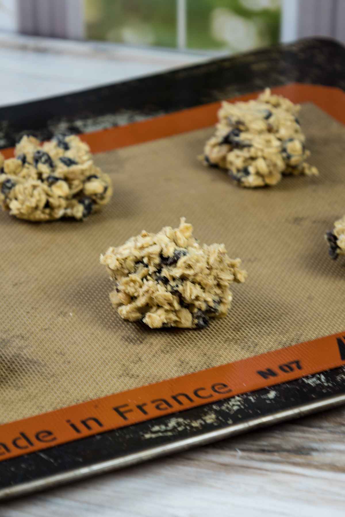 Cookie dough on silpat lined baking sheet.