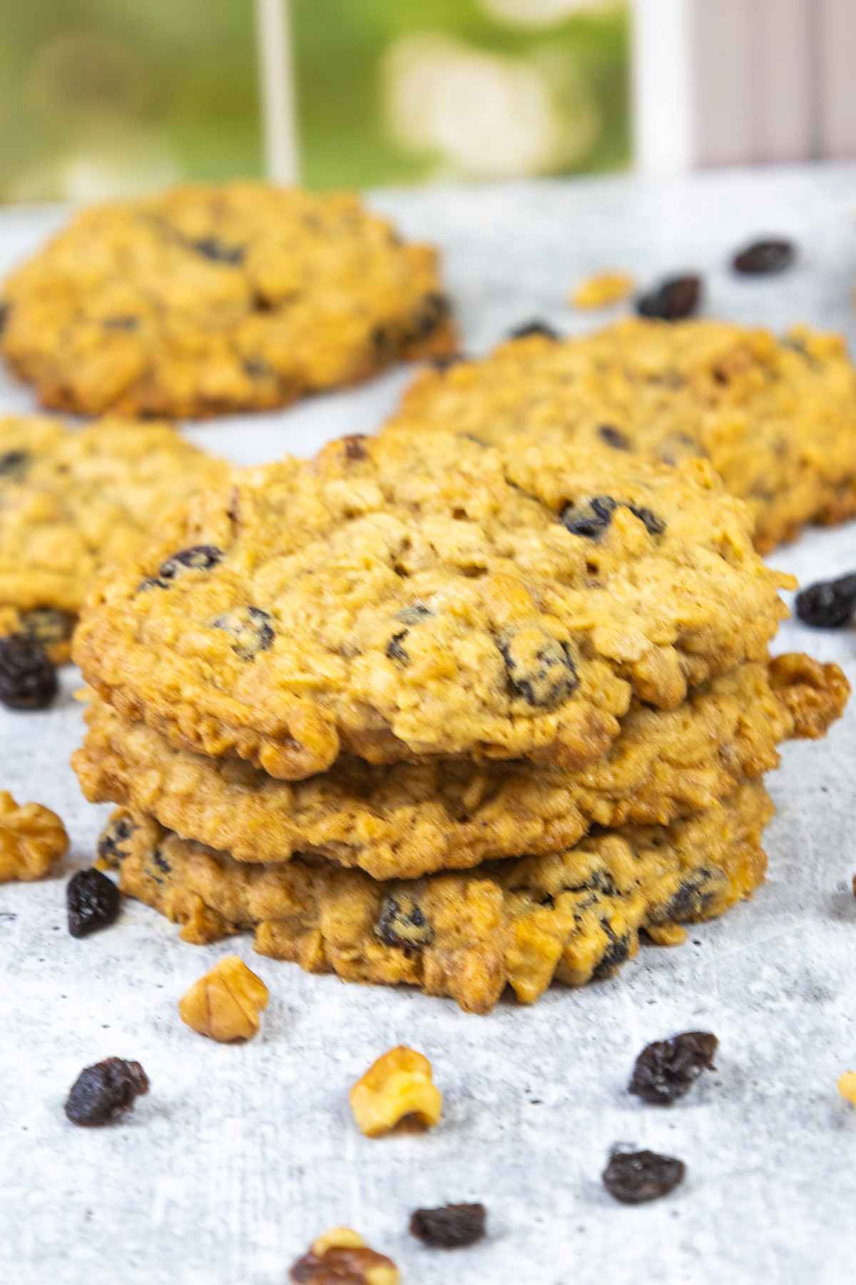 A stack of 3 oatmeal raisin walnut cookies.