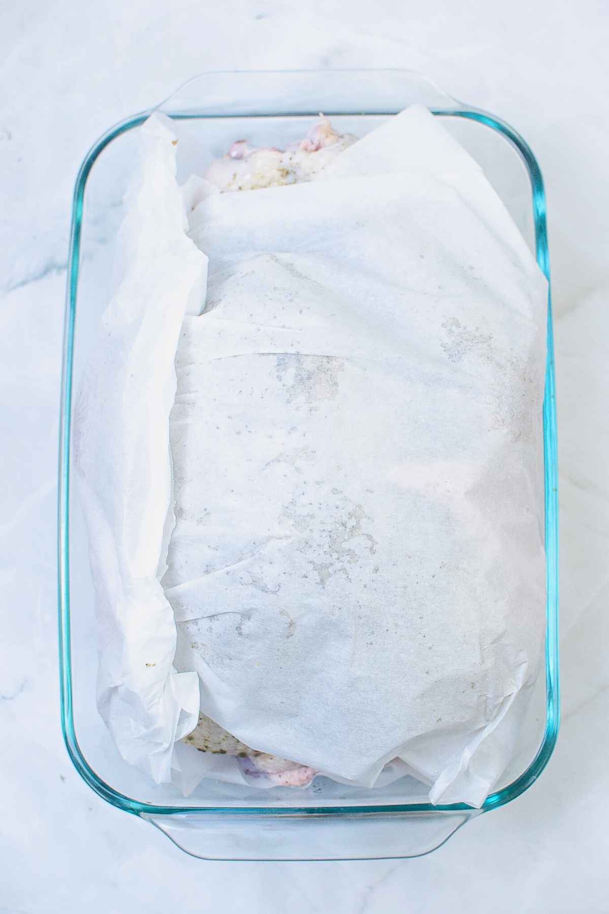 Raw turkey wrapped in parchment paper