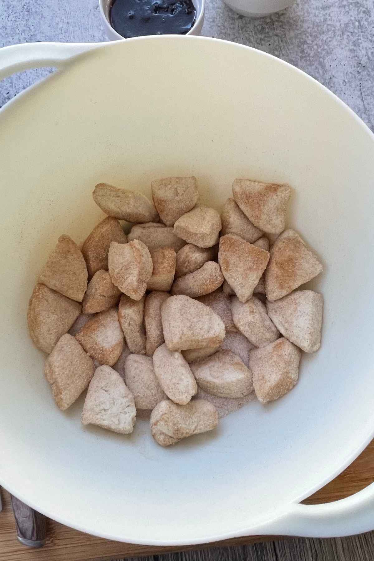 Cinnamon sugar coated quartered pieces of biscuit dough.