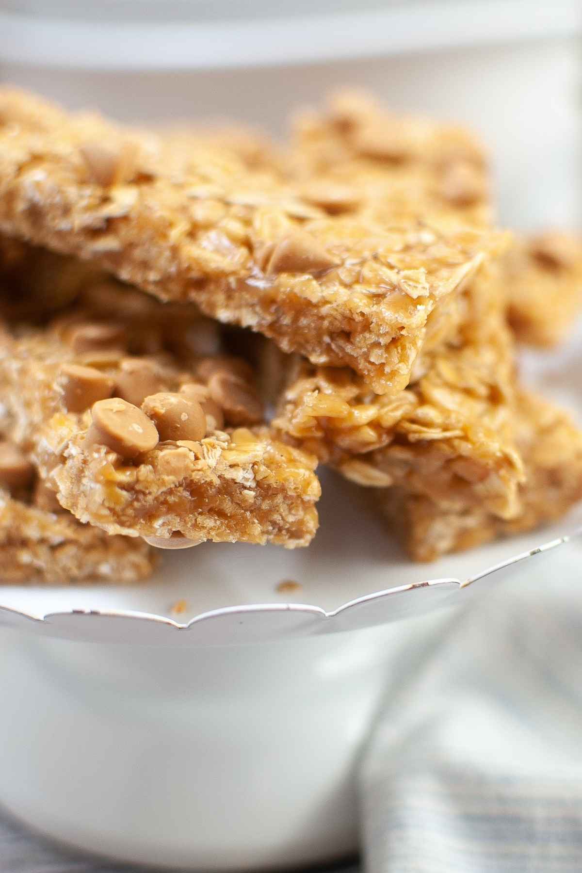 Upclose image of chewy granola bars on a white plate.