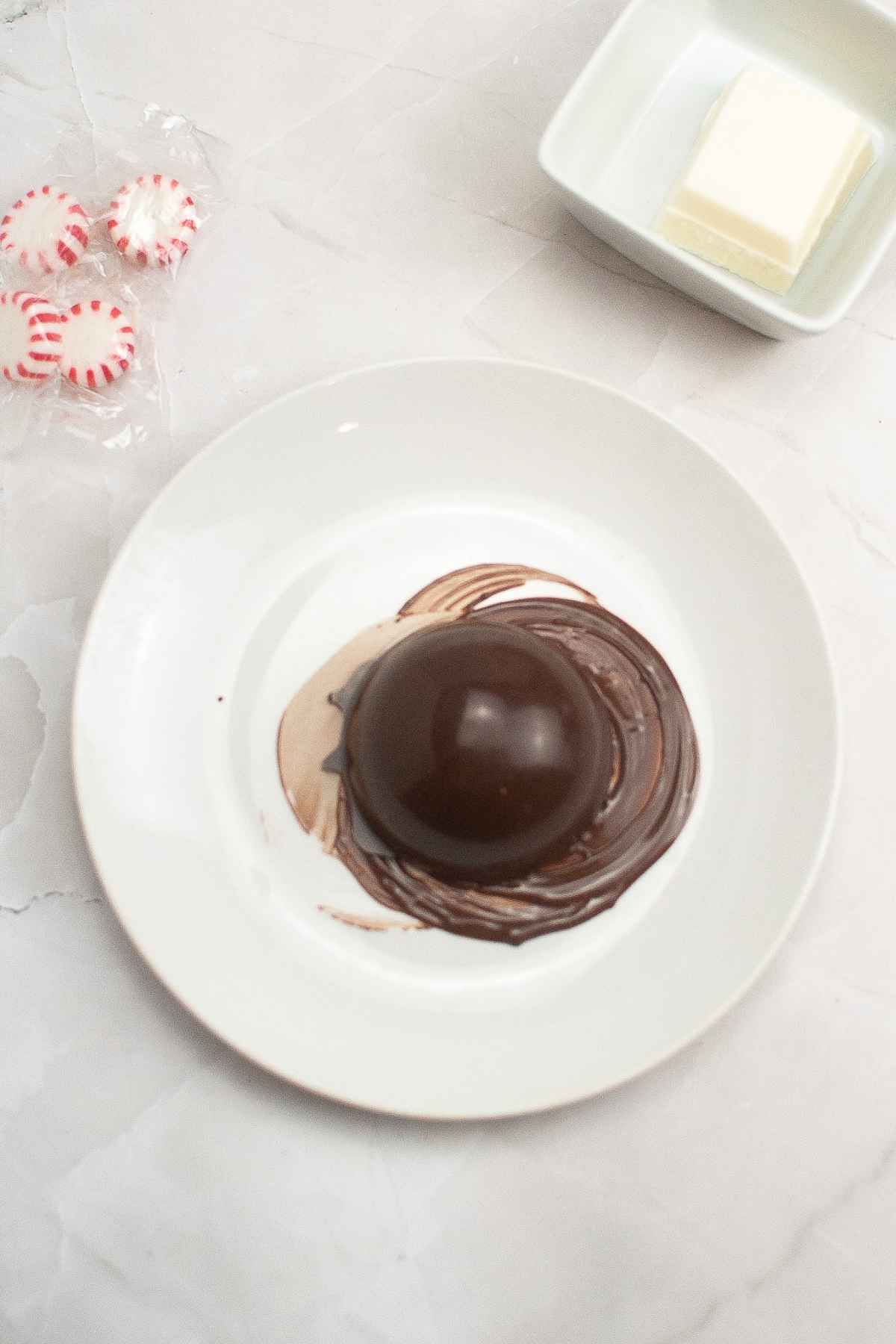 Chocolate shell on a warmed plate with edges of melted chocolate.