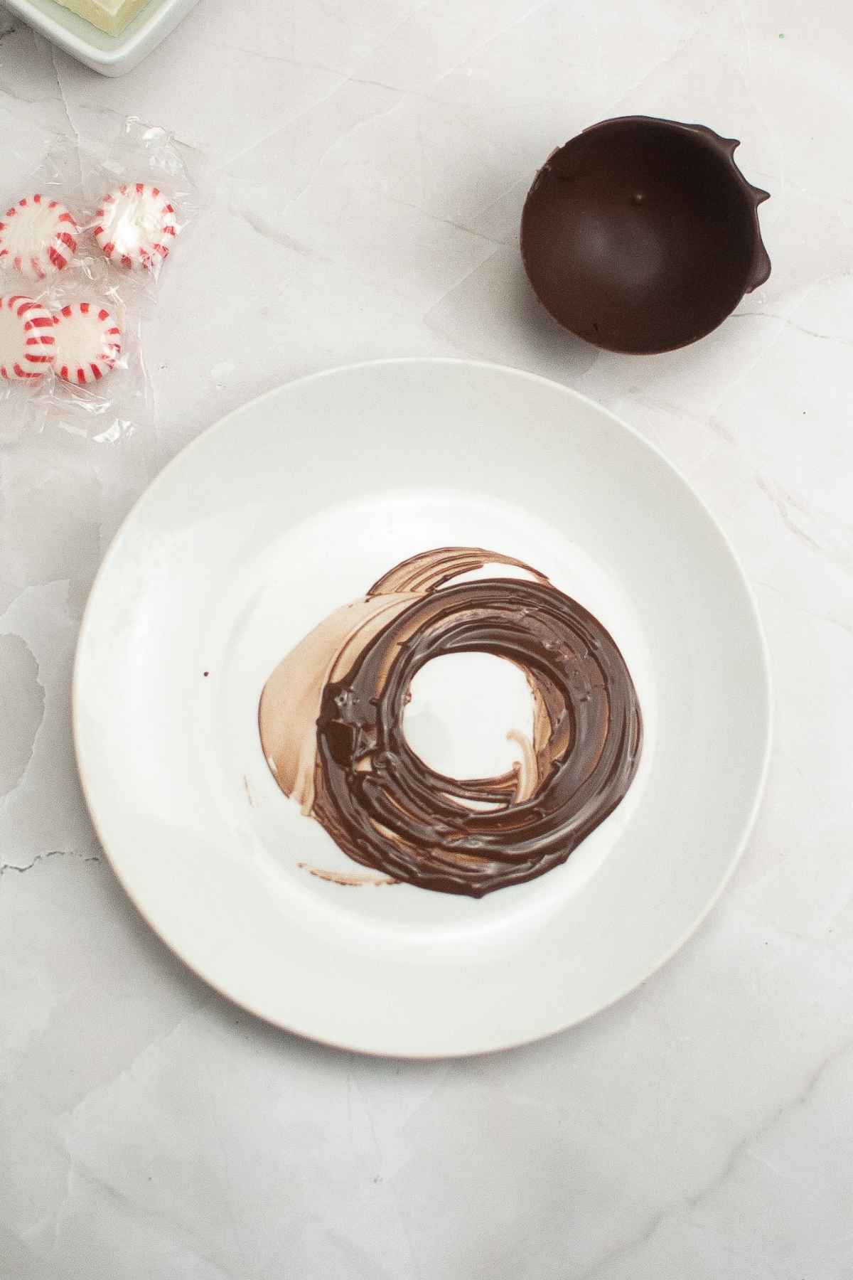 Melted milk chocolate on a white plate.