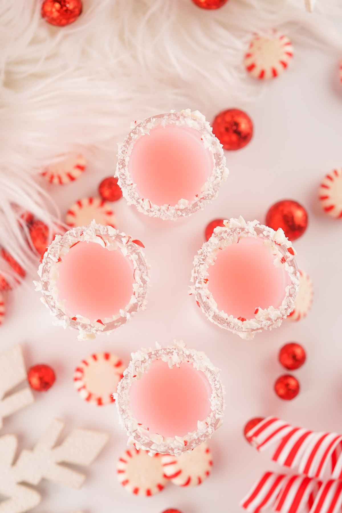 Overhead image of 4 shots of homemade peppermint vodka.