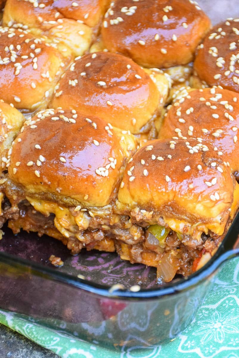 Baking dish with baked sliders in it.