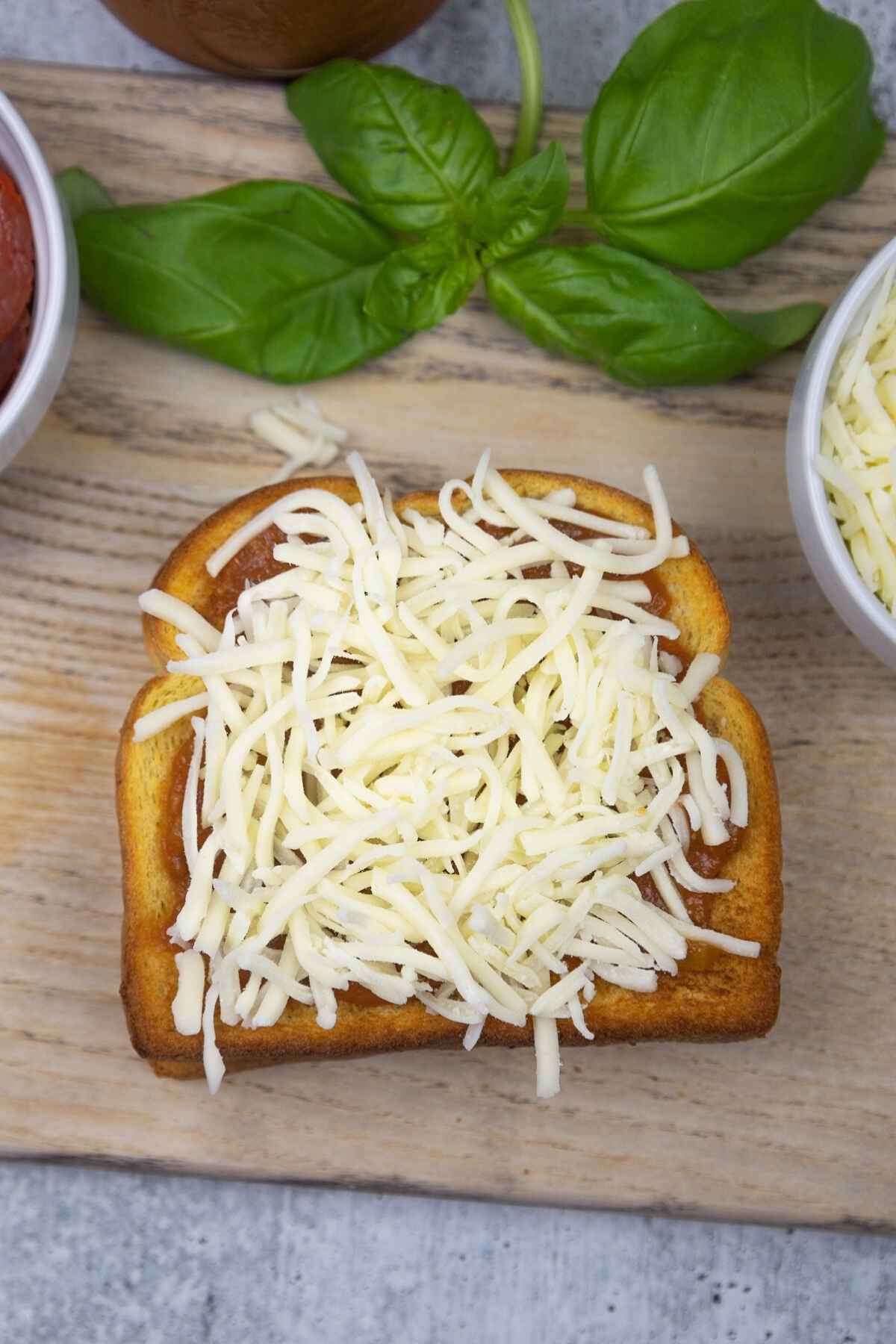 The shredded mozzarella cheese layer.