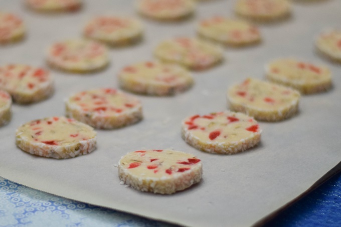 Santa's Whiskers Cookie slices on parchment paper lined baking sheet.