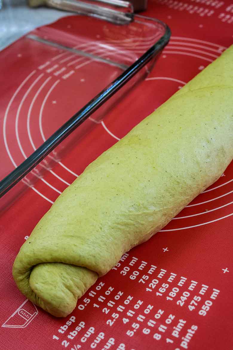 Dough has been rolled lengthwise and is now ready to slice.