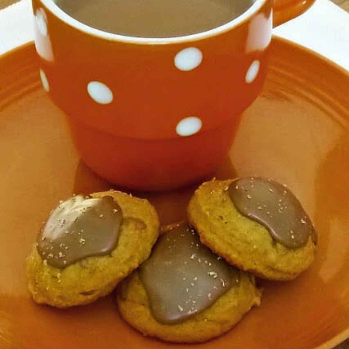 Pumpkin Spice Latte Cookies on a plate with a cup of coffee.