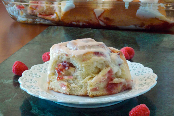 Raspberry Rhubarb Sweet Roll on a white plate.