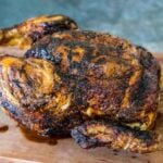 One whole chicken that was cooked in an air fryer rotisserie with golden brown and crispy skin.