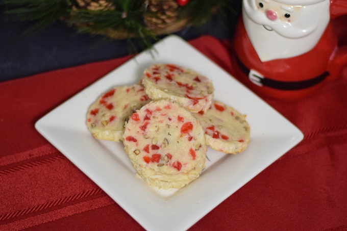 Overhead image of a small white plate stacked with santas whiskers cookies.
