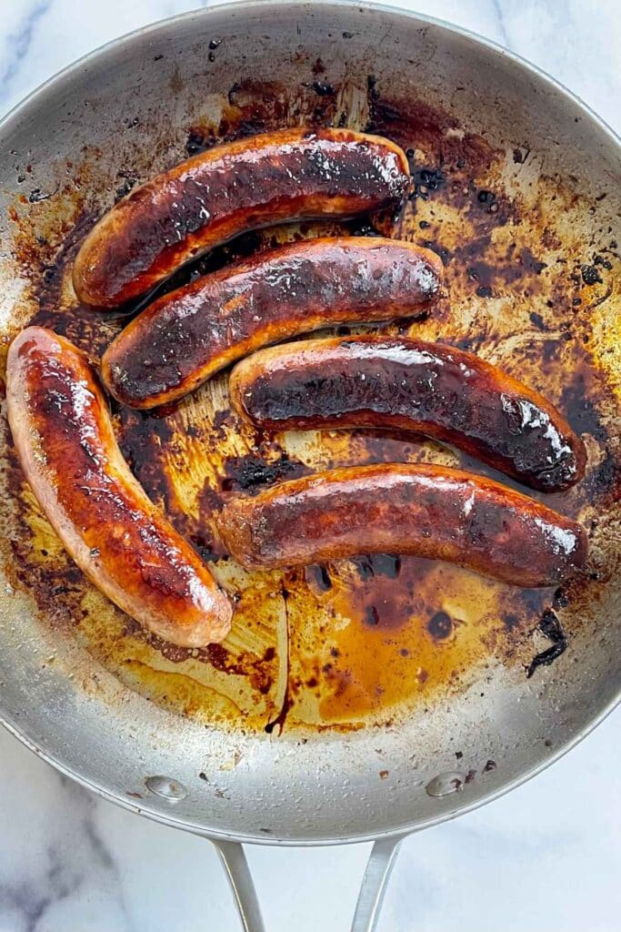 Cooked Italian Sausages in a skillet.
