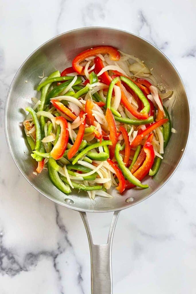 Peppers and onions in a large skillet.