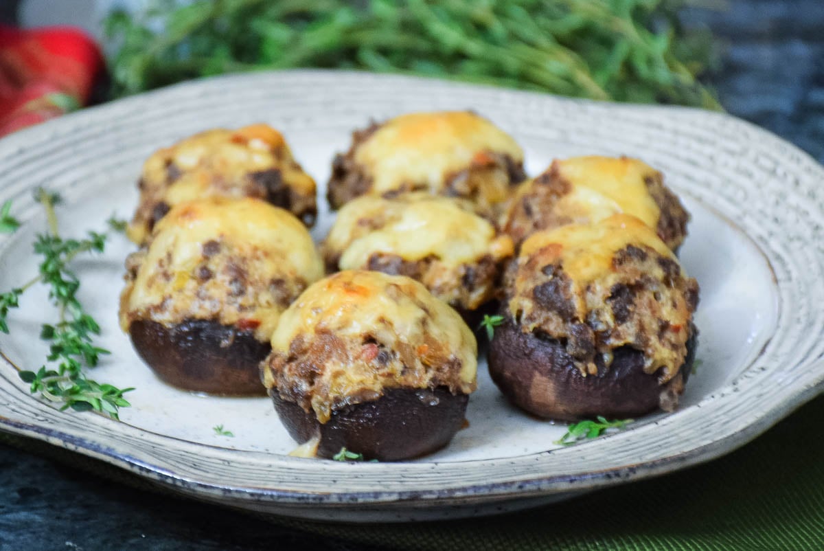 Sausage Stuffed Mushrooms on a holiday serving plate