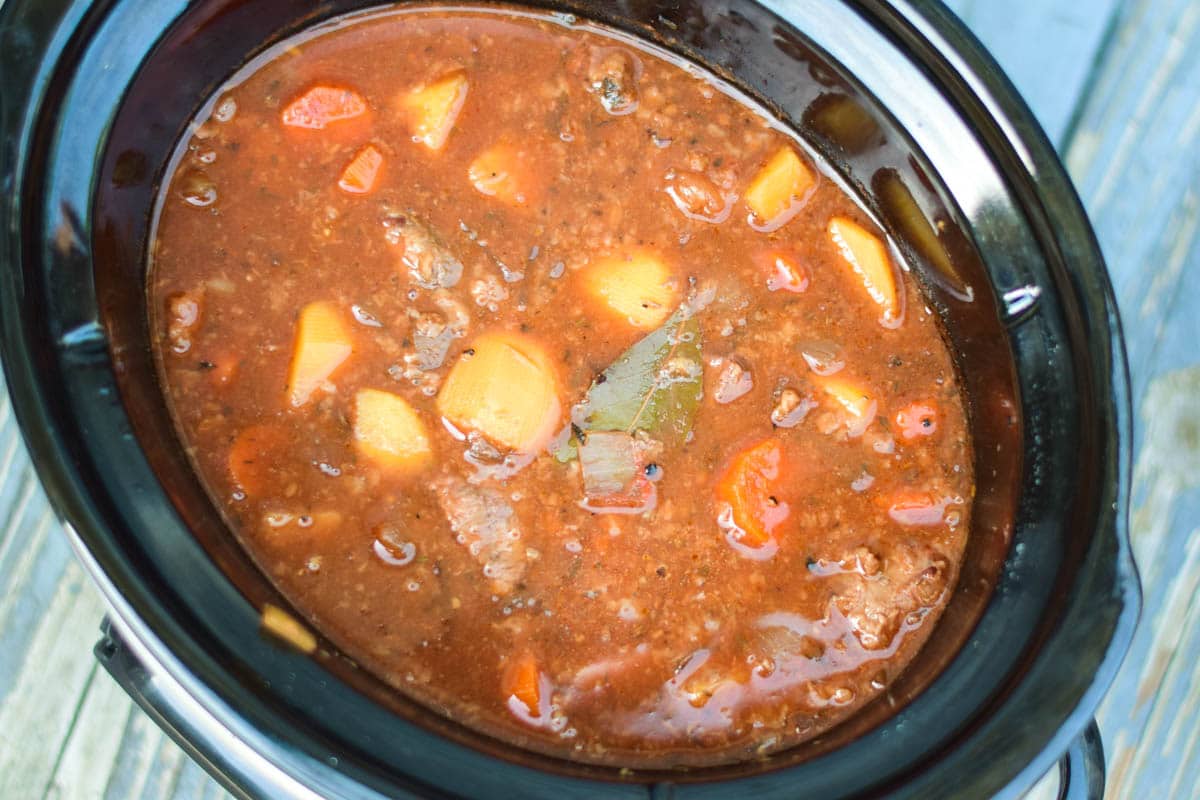 Meat, Potatoes, and Vegetables that have just finished cooking in the slow cooker.