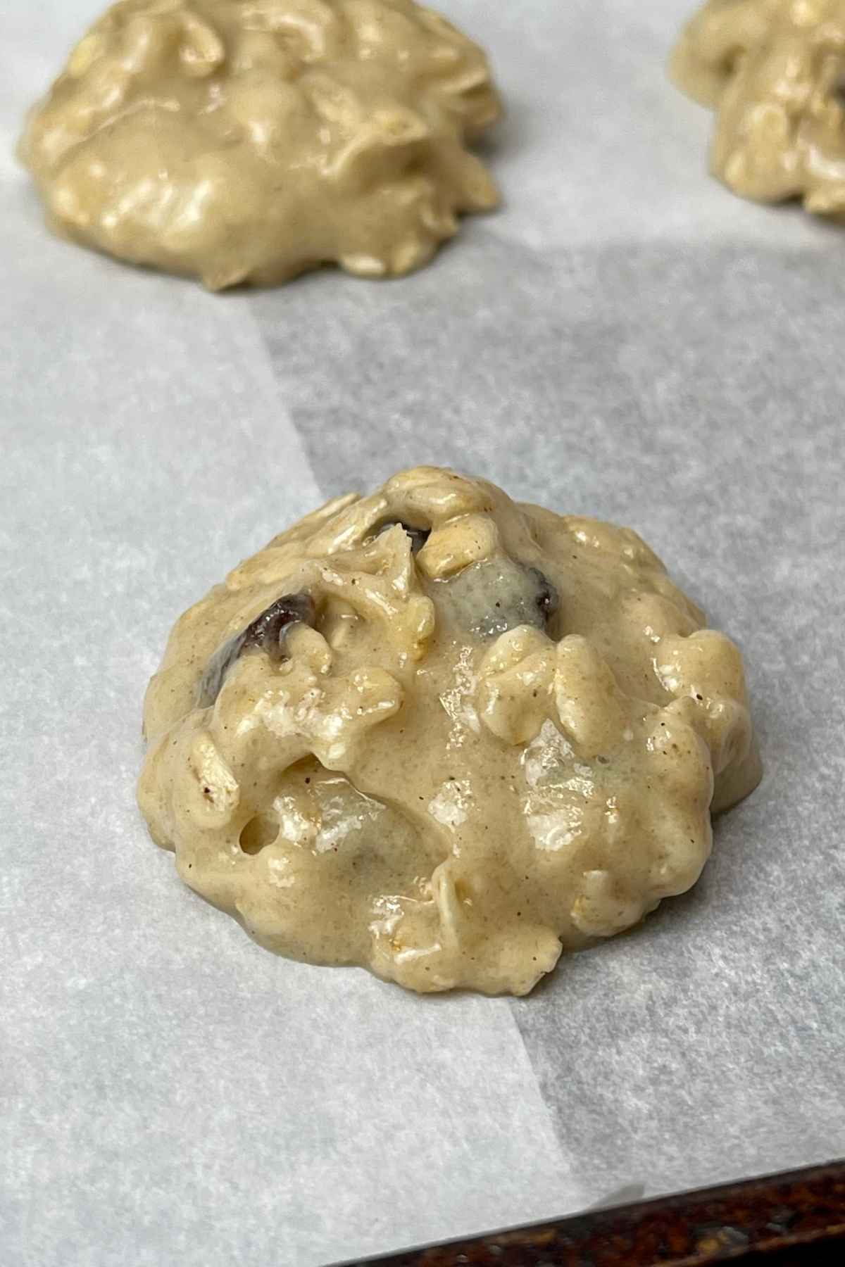 Cookie dough on parchment lined baking sheet.