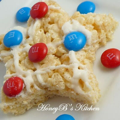 One star shaped no bake cereal treat decorated with red white and blue candy.