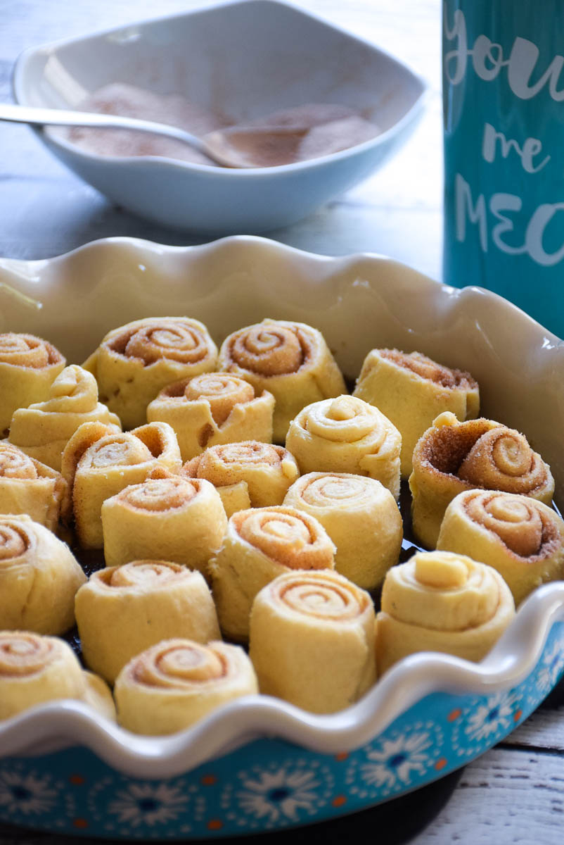 Unbaked swirled breakfast rolls in a baking dish.