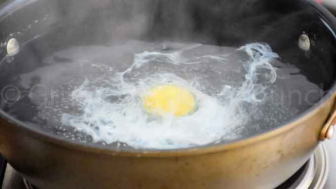 poaching an egg in boiling water