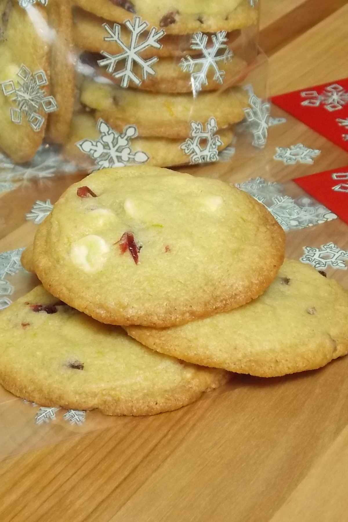 A pile of cookies ready to be bagged in Christmas food gift wrap.
