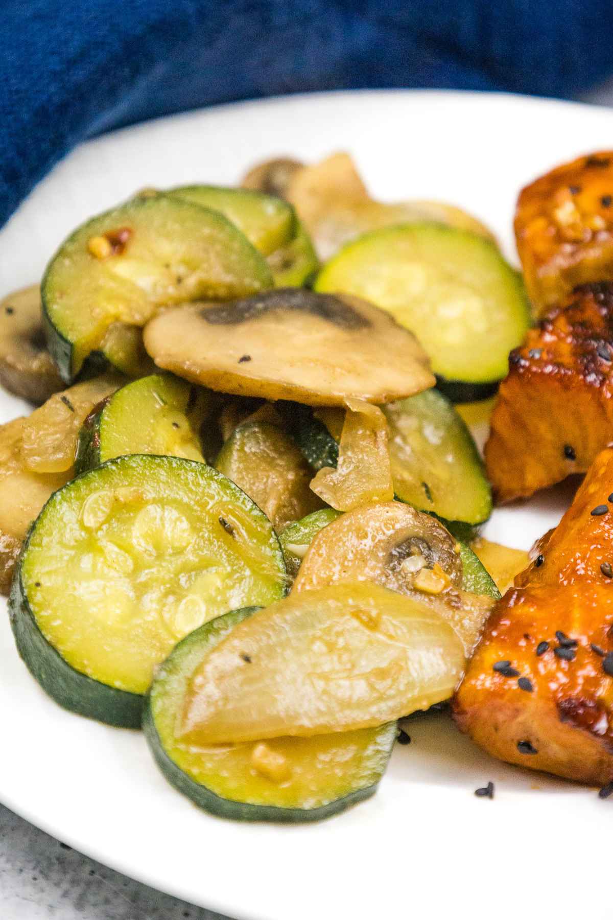 Sauteed zucchini and mushrooms on a plate.