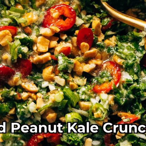 Shredded kale and cabbage salad with Fresno peppers and peanuts in a bowl with roasted peanut oil vinaigrette