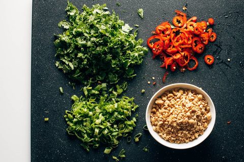 Blending ingredients for the roasted peanut oil vinaigrette in a blender jar